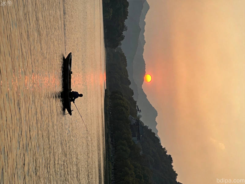 清晨湖边钓鱼场景，水面波光粼粼，钓竿插入水中，晨雾笼罩的宁静钓鱼环境